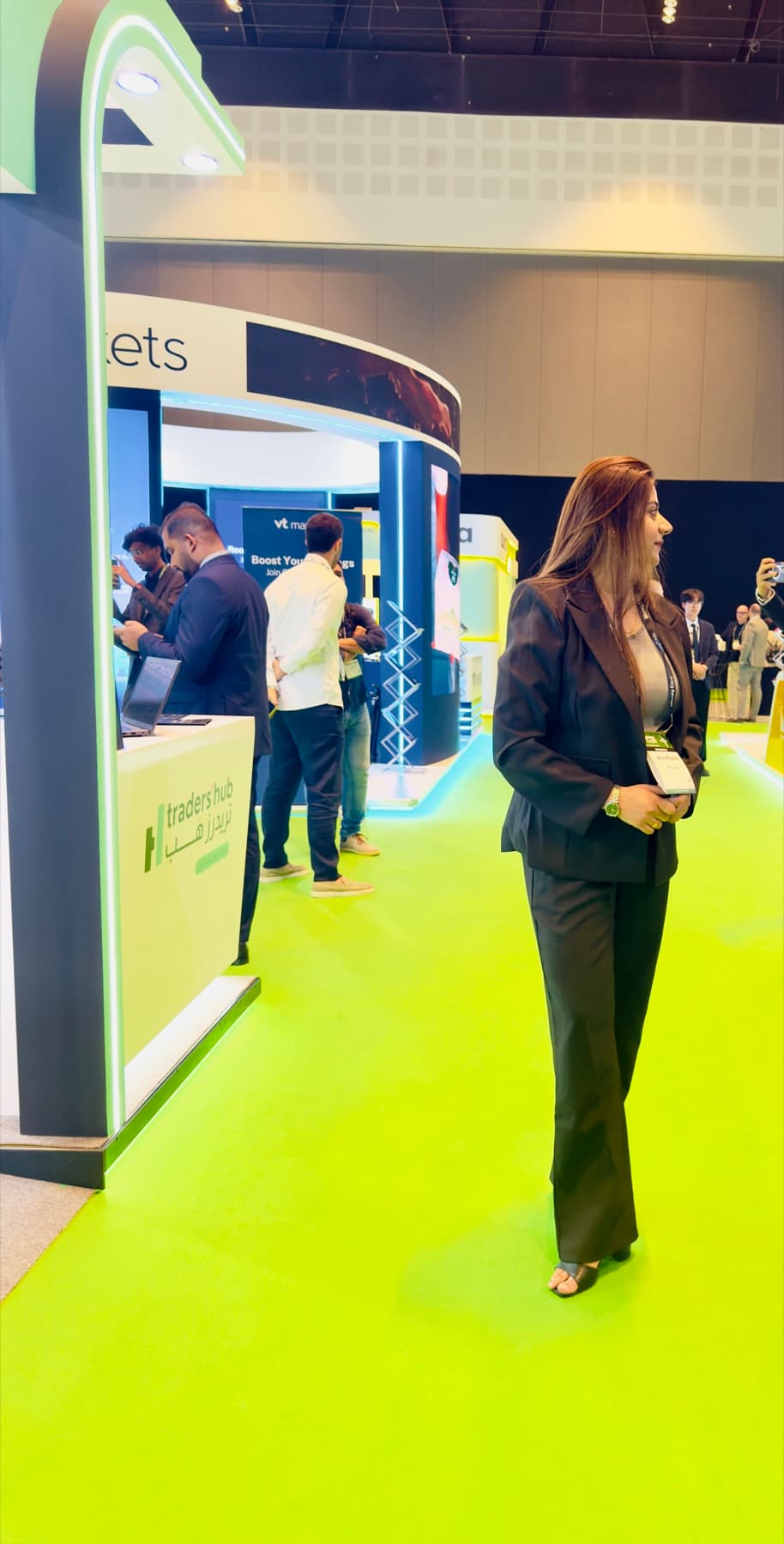Hira Majeed walking through the stands at a financial industry exhibition