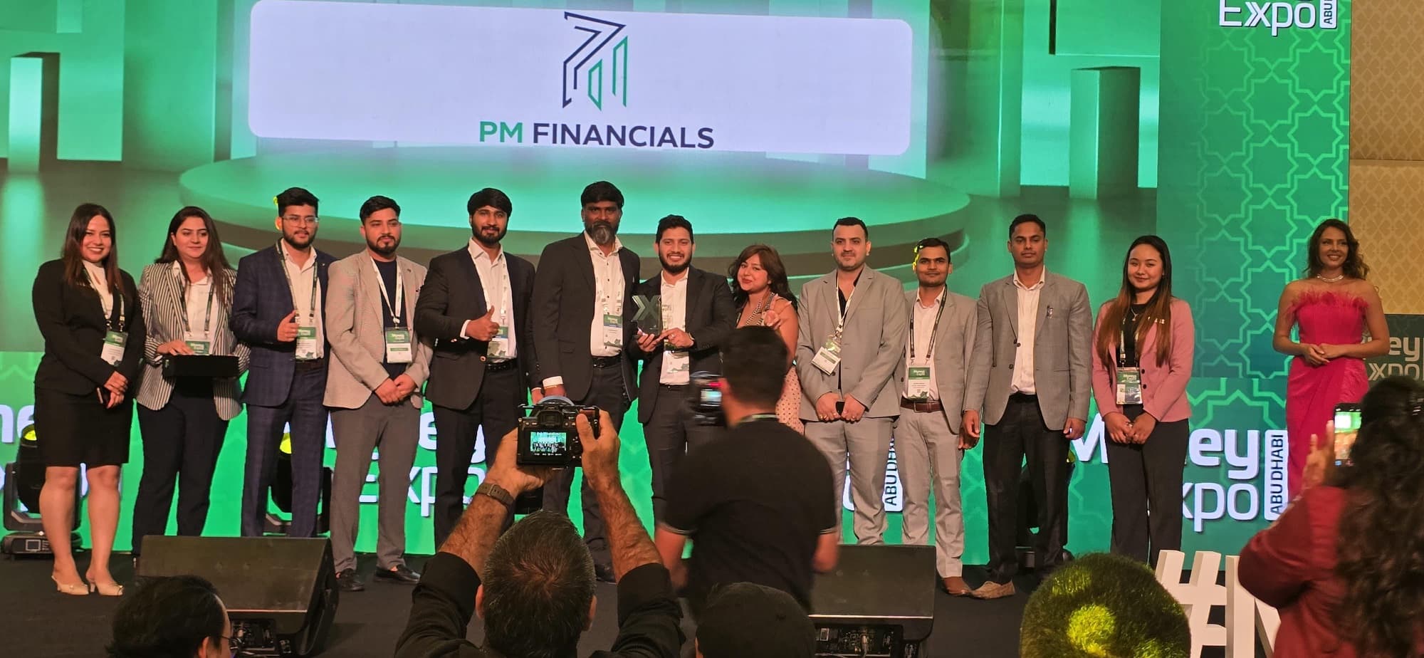 Industry professionals on stage at Money Expo Abu Dhabi during an awards presentation